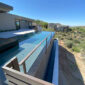 Infinity edge pool overlooking Scottsdale landscape, showcasing modern design and tranquil outdoor space.